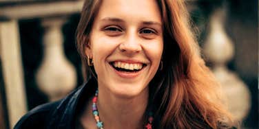 bright upbeat person radiating warm positive energy, illustrating the simple daily habits of people who never give off that heavy Debbie-downer vibe