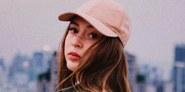 Woman looks back, wary of a friend who is about to drag her down