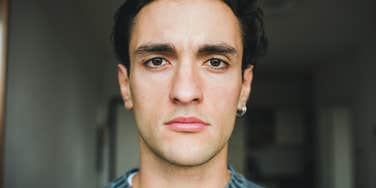 secretly manipulative man looking serious