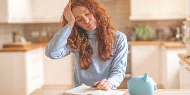 woman who grew up without money looking financially stressed