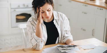 woman stressed about the price of buying a home on her income