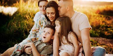 loving parents sharing a warm connected moment with their child, illustrating the simple habits that help couples grow stronger together after having kids.