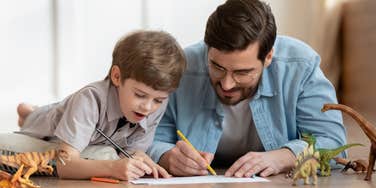 dad and son drawing on the floor