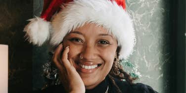 Little, Meaningful Ways To Feel Happier This Holiday Season Woman feels happier this holiday season.