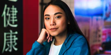 Thoughtful person sitting alone in a busy café, realizing insights about people that suddenly make everything feel less personal.
