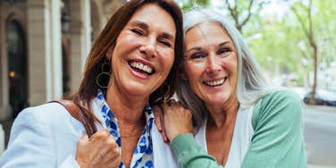 two friends from the 1970s hugging each other