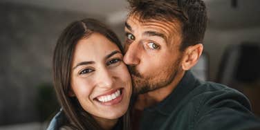 happy couple with husband kissing wife's cheek