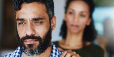 man thinking about leaving wife turned away from her