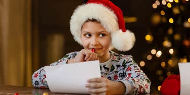 boy writing christmas list