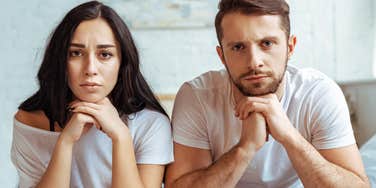 unhappy couple with bad body language sitting next to each other