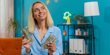 woman holding up money