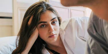 person staring off with quiet dread while their partner feels emotionally distant, capturing the subtle early signs people notice when they kinda know their relationship is already ending