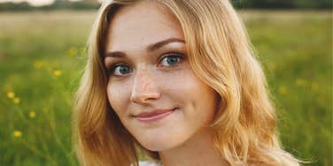 young intelligent woman smiling smugly