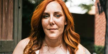 Woman with a calm, steady expression standing outdoors, capturing the quiet strength of people who don’t let a breakup completely derail them