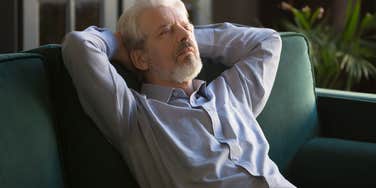 older man peacefully napping on his couch alone