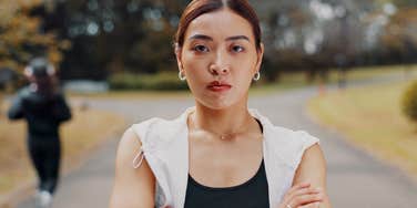 woman with low intelligence being defensive with arms crossed