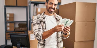 man holding up money