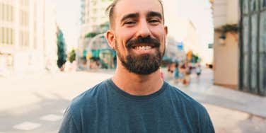 Smiling approachable man showing the science of good guys and the simple habits of grown men everyone likes talking to.