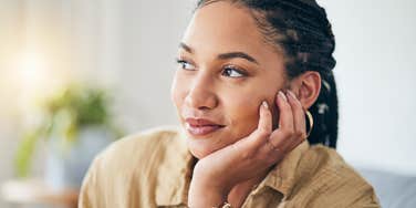 woman thinking with hand on her cheek