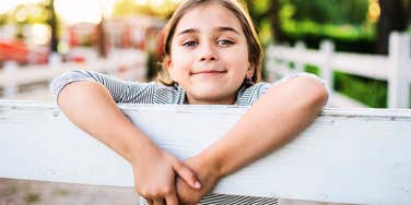 emotionally aware child showing kindness and thoughtful behavior in a small everyday moment, illustrating the simple signs of above-average emotional intelligence