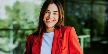 Simple Ways To Get An Amazing New Job During The Holidays, According To An Expert confident job seeker smiling after sending off a polished application during the holiday season, illustrating the simple expert-backed ways to land an amazing new job at year’s end