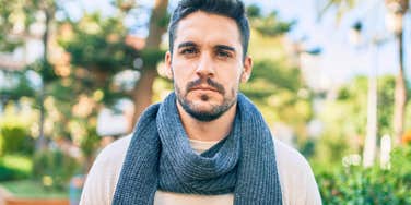 serious young man standing outside