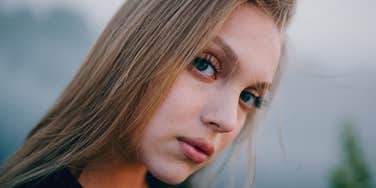 serious woman with a hidden cruel streak thinking