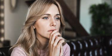 woman sitting at home struggling in silence