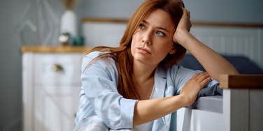 pensive woman in her bedroom not properly maintaining her home