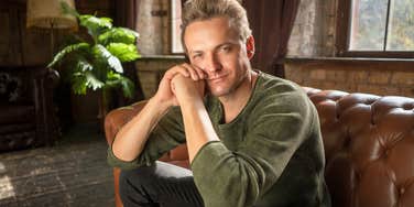 wealthy man with tacky behaviors sitting at home