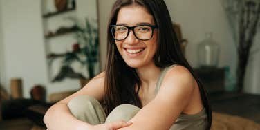 happy Type B woman sitting at home smiling