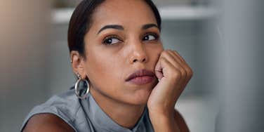 sad professional woman at work suffering from career trauma