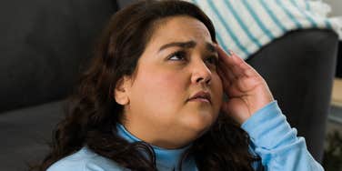 Woman is trying hard but the scale won't budge.