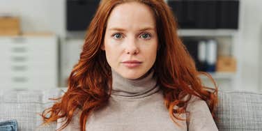 woman pretending to be a good person staring seriously