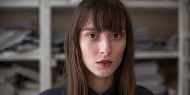 serious sullen woman lying about her life