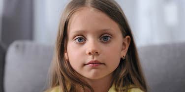 young girl staring with serious face