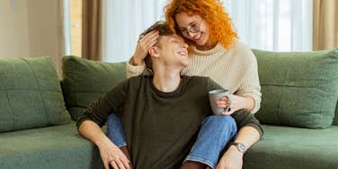 happy couple snuggling on the couch
