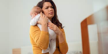 mom stressed about paying rent holding newborn baby