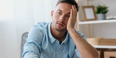 man who grew up with an absent father looking sad thinking