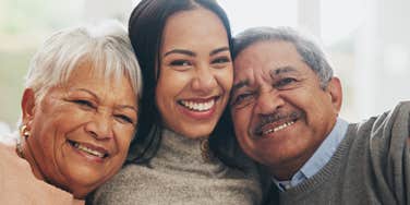 good genuine woman hugging her parents