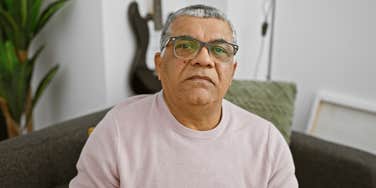 lonely older man sitting at home by himself