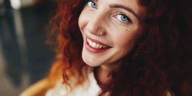 Introvert woman smiling despite finding things draining