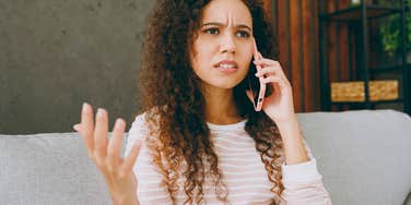 woman feeling oddly annoyed in phone conversation with her parents