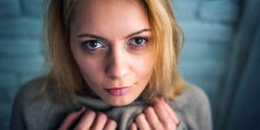 suspicious woman who's likely not a good person staring