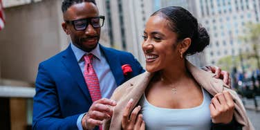 chivalrous gentleman offering his jacket to cold woman