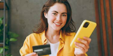 woman holding credit card about to spend money