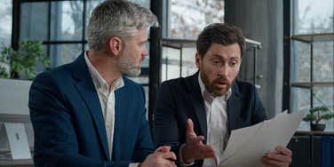 boss and employee arguing in office at work