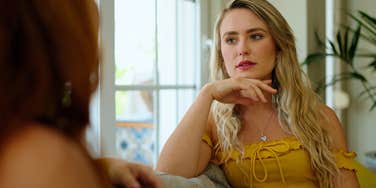 elegant woman about to cuss out friend in conversation