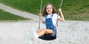 young girl on swing