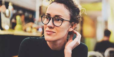 Woman sitting thoughtfully, reflecting on unresolved emotions that come from being with a partner who hasn’t fully matured